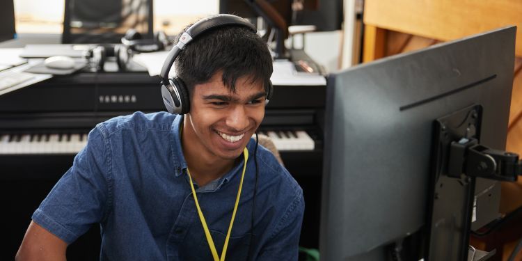 Short course participant at computer smiling 