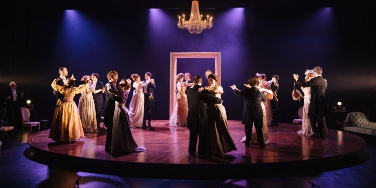 Guildhall singers dancing on stage in a ballroom scene