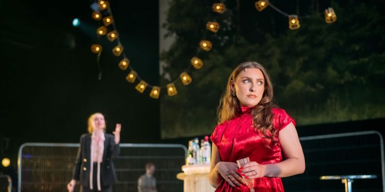 actors on stage with drinks in hand