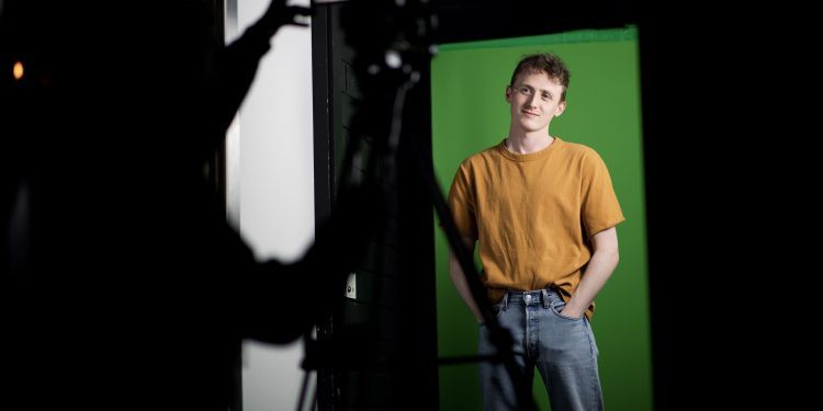 Actor in front of a green screen on the set of Senseless