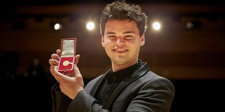 Tom Mole holding the music gold medal