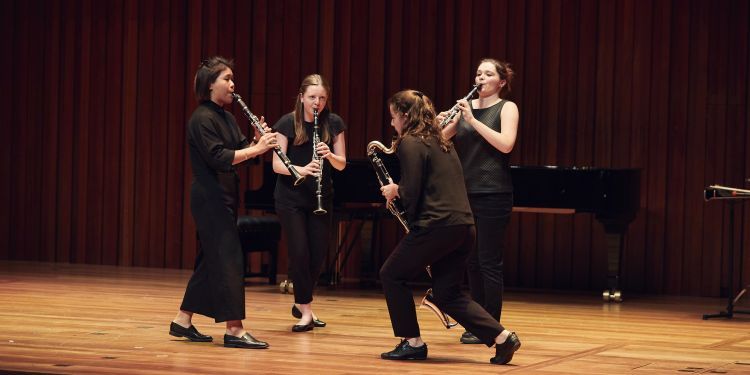 Clarinet quartet performing on stage in Milton Court