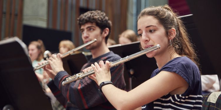 Flute players playing in an orchestal rehearsal in Silk Street Music Hall