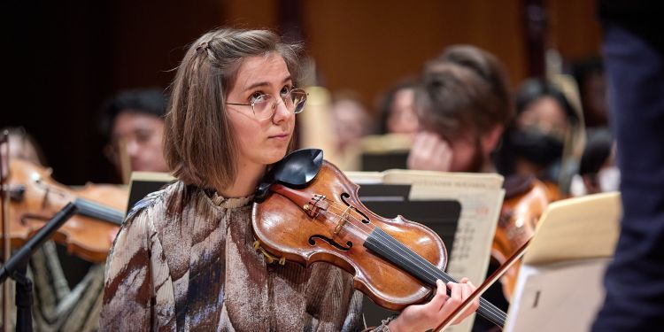 Violinist looks up in a rehearsal