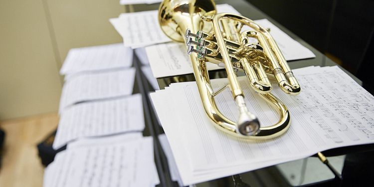 trumpet lying on lots of sheet music