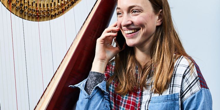 Harpist speaking on the telephone