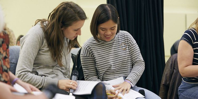 students looking over notebook