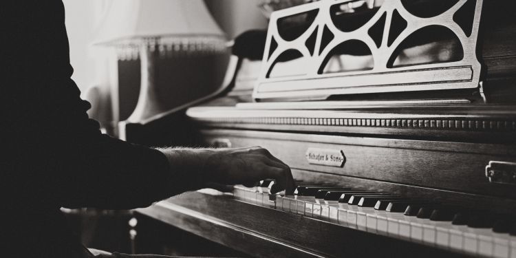 Close up of man's hands playing piano