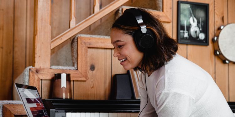 person with headphones at laptop 