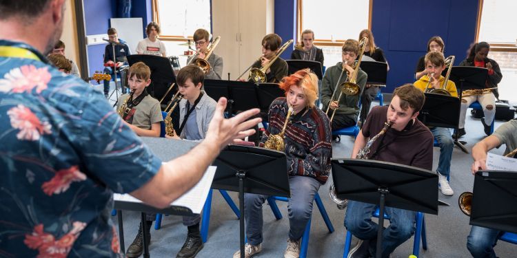 Young musicians playing brass instruments.