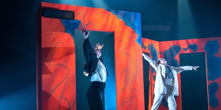 Photo of two students acting on stage