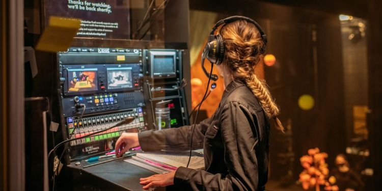 Photo of student backstage managing lighting