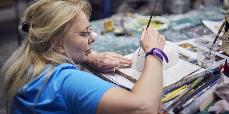 Participant decorating a mask 