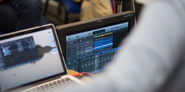 Two laptops set up as a live mixing desk for sound engineering.