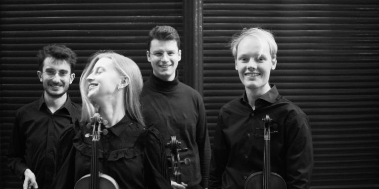 Black and white photo of Fibonacci Quartet smiling and holding instruments