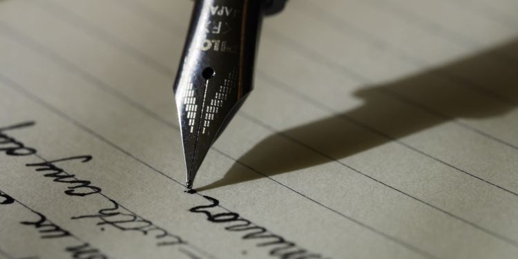 fountain pen writing on a piece of paper