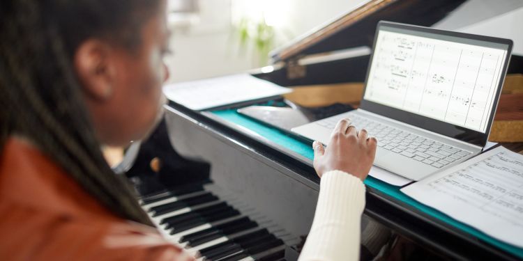 A young girl sits at a computer