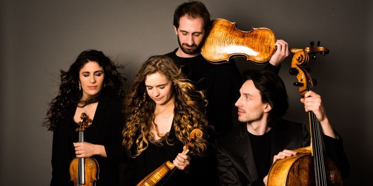 Confluence Quartet members dressed in black, holding instruments, with eyes closed