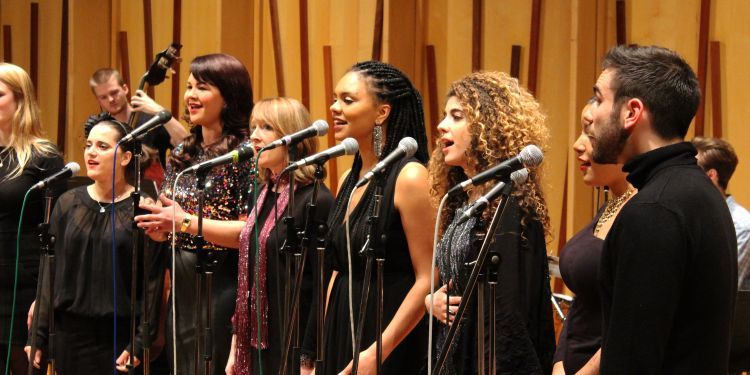 Guildhall jazz choir singing into microphones