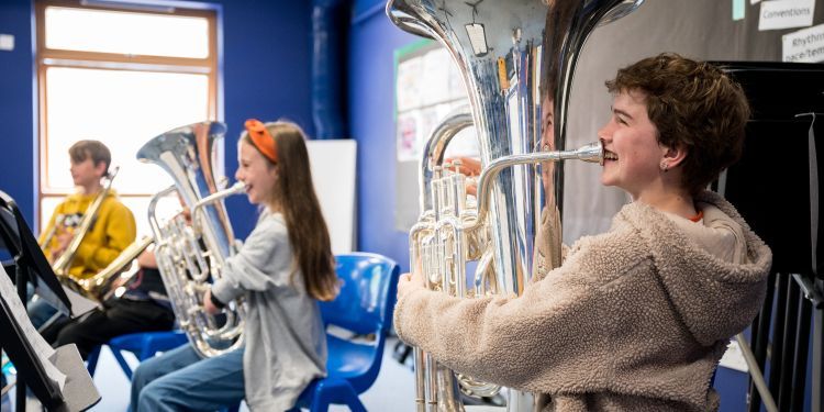 3 students, 2 of them playing euphoniums