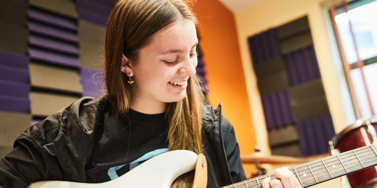 A girl plays guitar