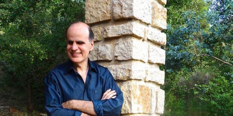 Pianist Bernard d'Ascoli standing outside next to pillar