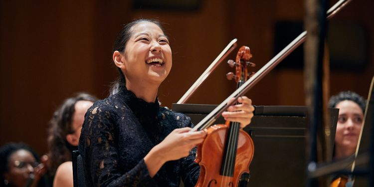 Strings student laughing during a rehearsal