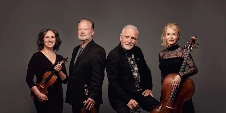 Brodsky Quartet standing up holding string instruments