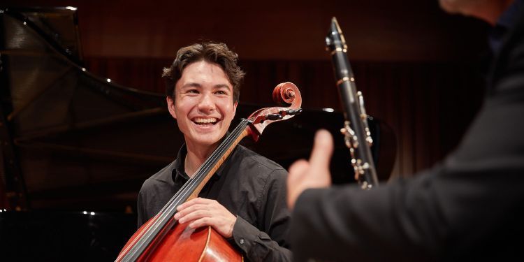 Guildhall School cello player smiling at colleague