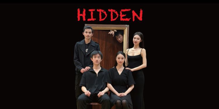 Hidden - five students in front of wooden door with 'HIDDEN' written above it in red