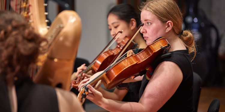 Two female students with a violin