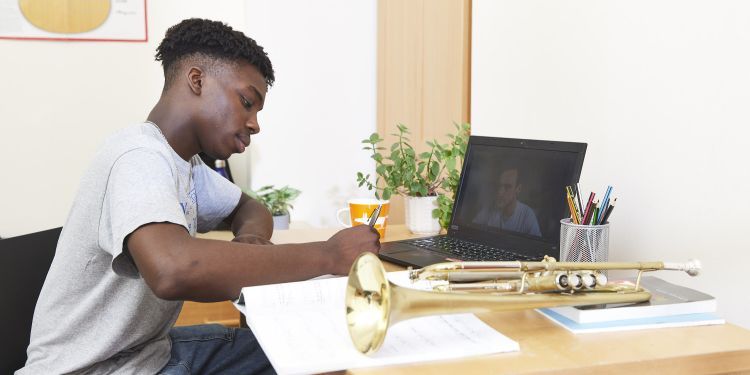 A boy sat at a desk 