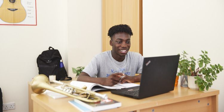 A boy sat at a desk 