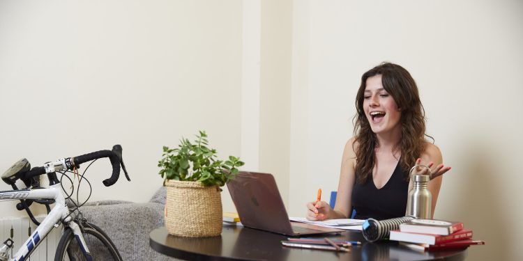 A girl sits at a desk 