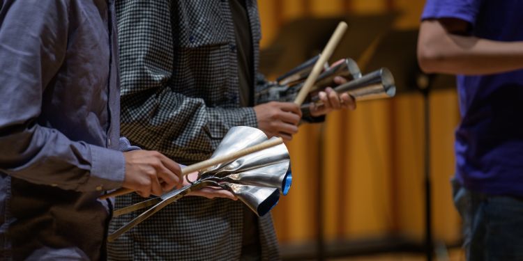 Close up image of a student using a percussion instrument