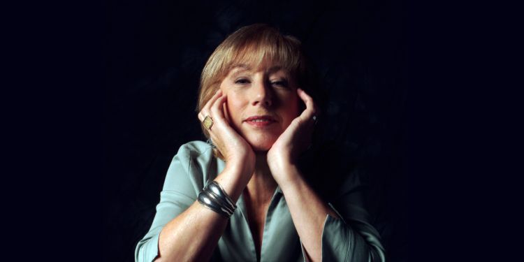 Norma Winstone sitting on chair with hands close to face