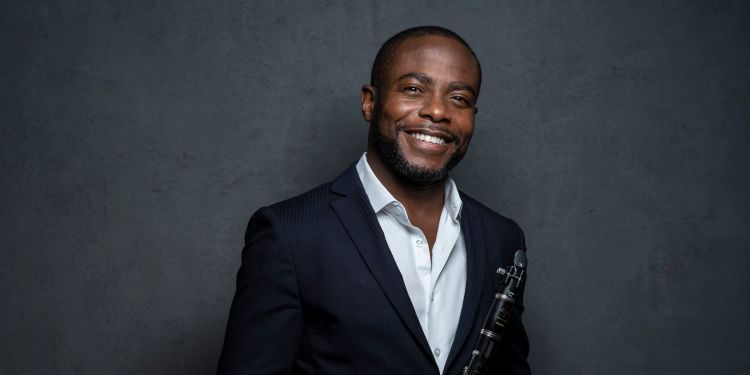 Anthony McGill smiling at camera holding clarinet