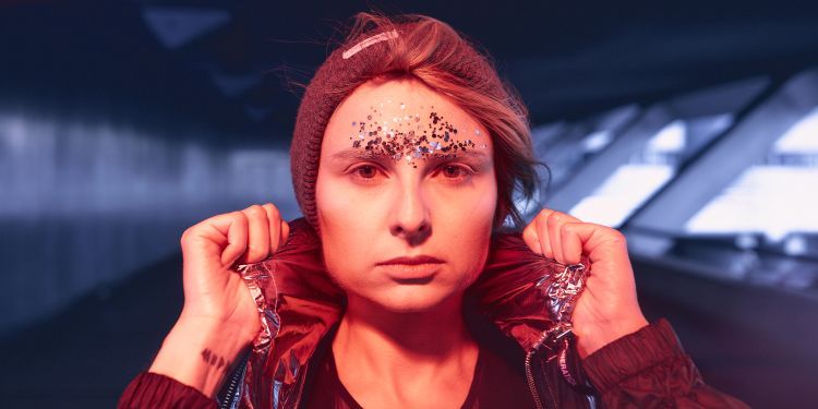 Headshot of Marta Śniady holding the collar of her jumper