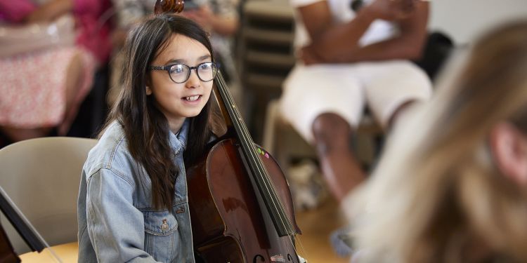 A girl holds a cello