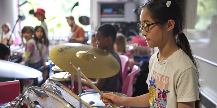A girl plays the drums 
