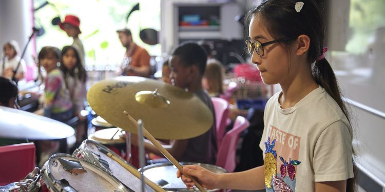 A girl plays the drums