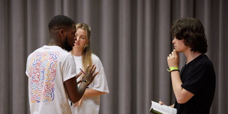 Image of one person directing two actors