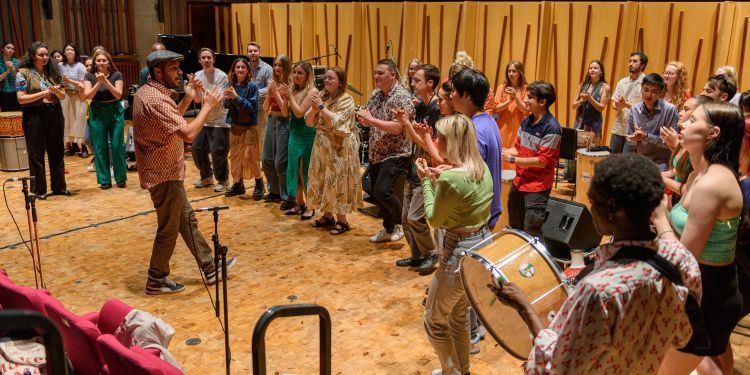 Photo from the Guildhall Improvisers’ Workshop from Summer 2023 of the group of singers and musicians performing