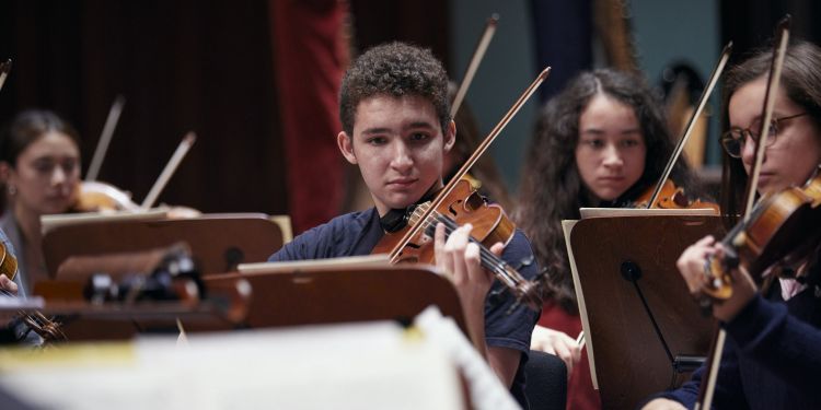 Four young violin players