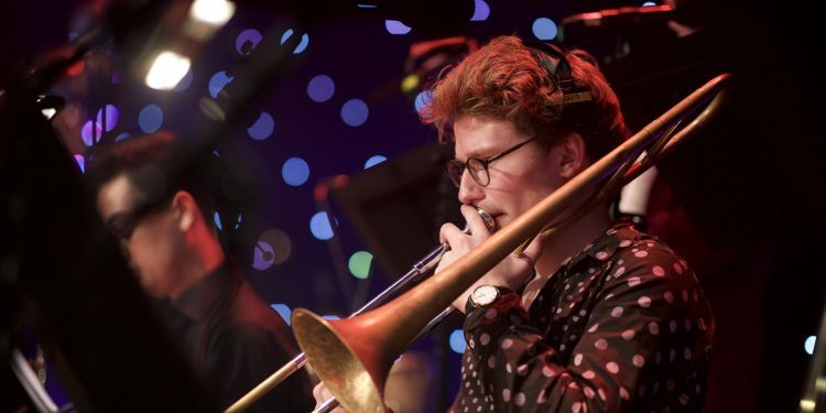Male member of Guildhall Studio Orchestra playing the trombone