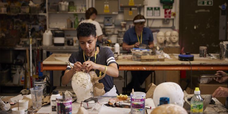 short course participant making a mask in props workshop