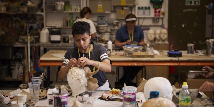 short course participant making a mask in props workshop 