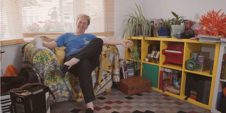Jon Davidson in his lounge on a sofa