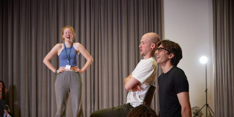 4 participants in a room laughing together 