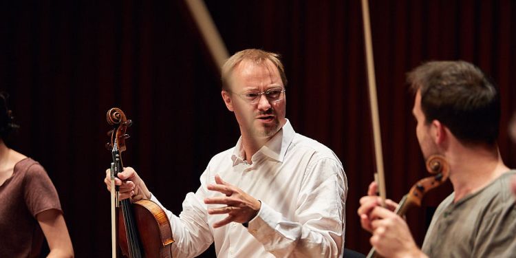 Matthew Jones teaching violin to a student 